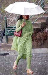 A girl walks in heavy rain on The Mall in Shimla on Monday