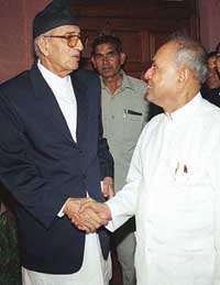 Former Nepalese Prime Minister and President of the country's Opposition Nepali Congress Party Girija Prasad Koirala shakes hands with Defence Minister Pranab Mukherjee in New Delhi on Monday. 