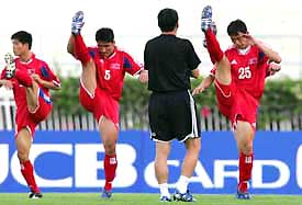 North Koreas head coach Yun Jong-su watches players during a practice session ahead of the World Cup qualifying Asia Group B soccer match against Japan in Bangkok