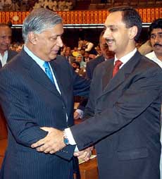 Pakistans Prime Minister Shaukat Aziz (left) greets Pakistans Minister of State for Finance Omar Ayub Khan after presenting the Budget, 2005-2006, during a National Assembly session in Islamabad on Monday.
