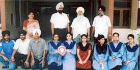 Meritorious students of Baba Ishar Singh Senior Secondary School with members and trustees of the school management in Ludhiana