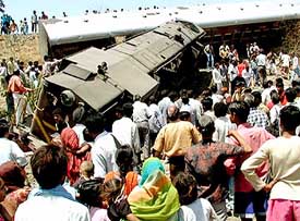 Onlookers look at the wreckage of a train in Ratlam district, 300 km from Bhopal on Monday. 