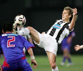 Juventus Pavel Nedved of the Czech Republic controls the ball against FC Tokyos Teruyuki Moniwa during a friendly match in Tokyo
