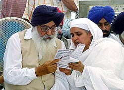 SGPC president Bibi Jagir Kaur and former Punjab Chief Minister Parkash Singh Badal discuss a point at a religious function in Hisar on Wednesday. 