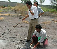 A team of Punjab Pollution Control Board officials collects samples of fly ash dumped in Chehlan village stadium on Wednesday. 