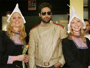 Bollywood actor Abhishek Bachchan is welcomed by Dutch girls in traditional costumes as he arrives at Schiphol airport, Amsterdam