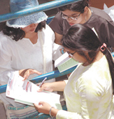 Admission seekers taking a close look before submitting their forms in Delhi University in the Capital on Thursday.