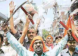 Activists of the Shiv Sena and Bajrang Dal hold swords and shout slogans against BJP President L.K. Advani at Katra in Allahabad on Thursday