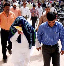 A CBI official takes one of the accused in the Amritsar sex scandal to the Patiala district courts