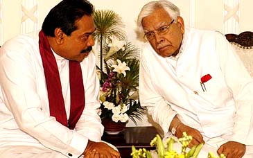 External Affairs Minister K Natwar Singh listens to Sri Lankan Prime Minister Mahinda Rajapakse during a breakfast meeting at Temple Trees in Colombo on Friday