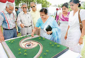 Family members of war heroes look at 'Chandigarh War Memorial' model at Sector 3, Chandigarh, on Saturday.