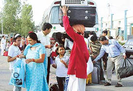 Passengers disembark from an AC bus at the Chandigarh railway station on Saturday. 