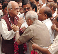 BJP President L.K. Advani is greeted by senior party leader Madan Lal Khurana at the party office in New Delhi on Saturday.
