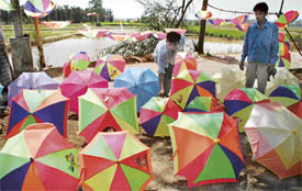 Umbrellas of various hues and shades beckon passersby on the GT Road near the Sutlej in Ludhiana