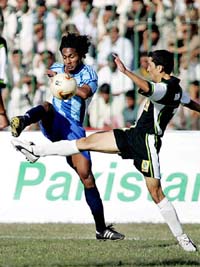 Indias Clifford Miranda fights for the ball with Pakistans Abdul Aziz during the first encounter of the three-match series at the Ayub Stadium in Quetta on Sunday