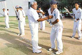 Dronacharya awardee D.P. Azad gives batting tips to budding cricketers at the ongoing under-17 cricket camp at the PCA, Mohali