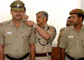 Delhi Commissioner of Police Dr K. K. Paul giving an out-of-turn promotion to ASI Bhoop Singh and Constable Attar Singh during a ceremony at Police Headquarters in the Capital