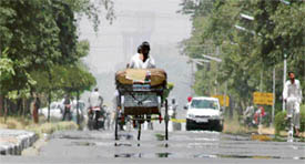 Rays of the summer sun form illusions of water on a road in Ludhiana on Tuesday