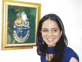 Artist and her muse: Anchal Bhrany shows her Tanjore glass painting at the Art Gallery in the city.  A Tribune photo
