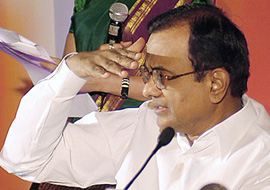 Finance Minister P. Chidambaram gestures after the launch of interconnected ATMs in New Delhi on Wednesday.