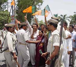 Policemen try to control agitated BJP activists protesting against the removal of a statue of Deen Dayal Upadhyaya at Rampur in Uttar Pradesh