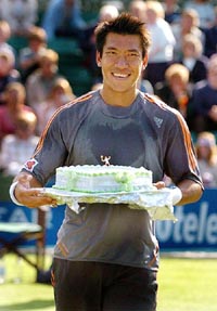 Defending champion Paradom Srichaphan of Thailand receives a birthday cake after his match against Mark Hilton at the 10tele.com in Nottingham on Tuesday