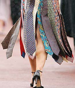 Racegoer Tricia Lee in a dress she made herself from 28 ties, walks through the crowd on the second day of Royal Ascot at York on Wednesday