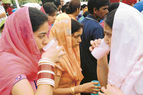 Fountain-head of faith: Women in Jalandhar partake of chabeel water during the martyrdom anniversary of Guru Arjan Dev.