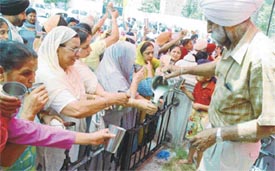 People partake of a sweetened drink served to commemorate the martyrdom day of Guru Arjan Dev in Ludhiana on Thursday
