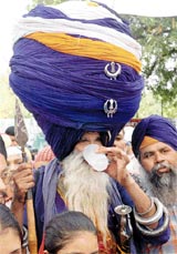 A Budha Dal Nihang wearing a 350-metre-long turban has Chhabbil on Guru Arjun Dev martyrdom day in Jalandhar on Thursday