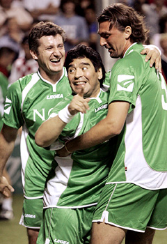 Diego Maradona celebrates with Davor Suker and Goran Ivanisevic after scoring a goal during a charity soccer match at Novi Vinodolski in Croatia
