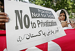 Activists from the Anti-Privatisation Alliance, an alliance of various trade union bodies and political workers, hold a placard to protest against the governments decision to privatise Pakistan Telecommunication Limited during a rally in Karachi on Thursday.