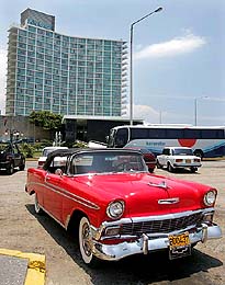 A vintage Chevrolet is parked outside Hotel Riviera next to Havanas seafront boulevard El Malecon