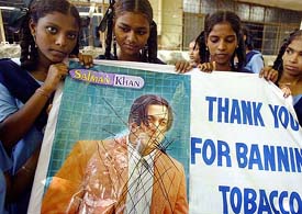 Schoolchildren hold banners as they participate in a rally to support the governments decision to ban smoking in films in Mumbai on Friday