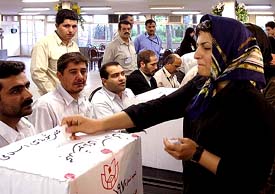 An Iranian woman casts her ballot for the Iranian presidential election in Teheran on Friday