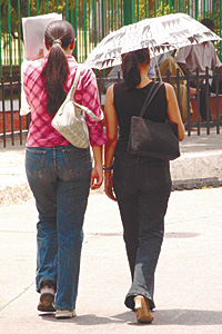 IF YOU GOT TO GO, YOU GOT TO GO: Its business as usual for these two girls though most Delhiites preferred to stay indoors.