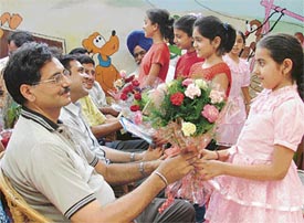 Students of Love Dale present bouquets to their fathers as they celebrated Father’s Day
