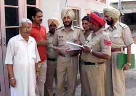 A police party records particulars of tenants and vehicles at a house in Mandi Ahmedgarh