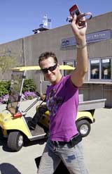 Ferraris Formula One driver Michael Schumacher of Germany waves to fans as he arrives for practice at Indianapolis Motor Speedway on Friday