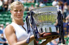 Belgiums Kim Clijsters with the trophy after beating Russias Vera Douchevina in the final of the Eastbourne grasscourt tournament in southeast England 