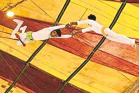 Trapeze artistes sail through the air during a show of Asiad Circus in Sector 5, Panchkula, on Sunday