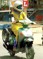 With the Capital sizzling at 43 degree Celsius, this woman ventures out with her face, hands and arms adequately covered on Sunday