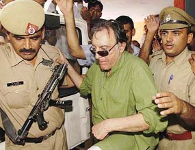 Former Indian cricket captain Nawab Mansur Ali Khan Pataudi, who surrendered in a court on Saturday in connection with the black buck poaching case, gets into a police car after his remand was extended for one more day, in Jhajjar on Sunday.