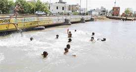 Children continue to swim in the Dugri bridge canal despite the recent drowning 