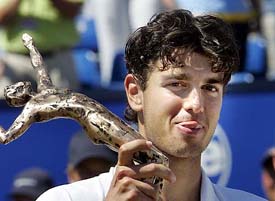 Croatias Mario Ancic holds the trophy after his victory over Frances Michael Llodra in the final of the Ordina Open tennis tournament at Rosmalen, the Netherlands