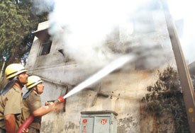 Delhi fire personnel try to douse the flames at Sapru House in the Capital on Monday