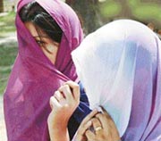 Girls cover their face to escape the scorching heat in Ludhiana on Saturday