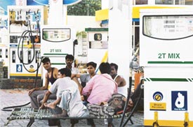 Employees rest as petrol pumps remained closed in Ludhiana on Monday due to petroleum dealers strike