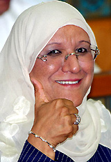 The first Kuwaiti woman minister, Massouma al-Mubarak, reacts after reading her oath of office in Parliament on Monday