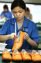 A Chinese woman works at the Jiulong shoe factory in the southern Chinese city of Wenzhou on Tuesday
